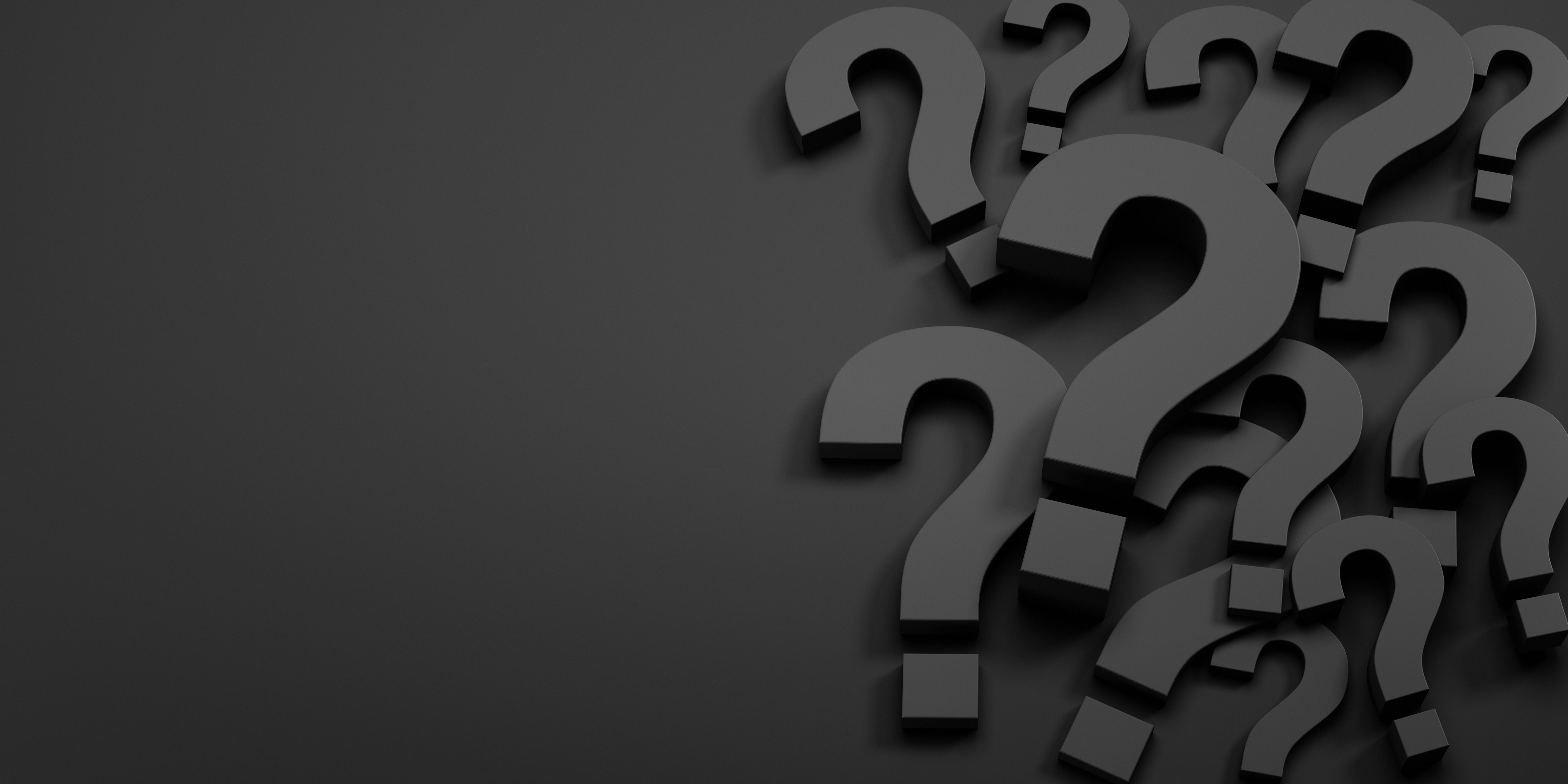 FAQ - Fragezeichen vor einem schwarzen Hintergrund